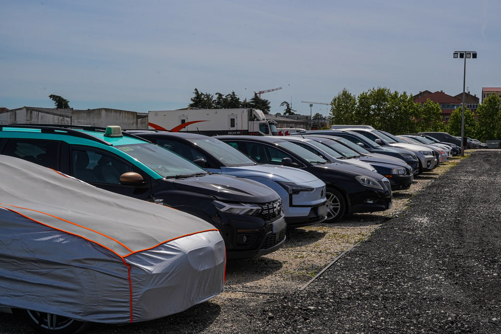 Cars parked securely in Check-in Park's fenced, monitored lot.